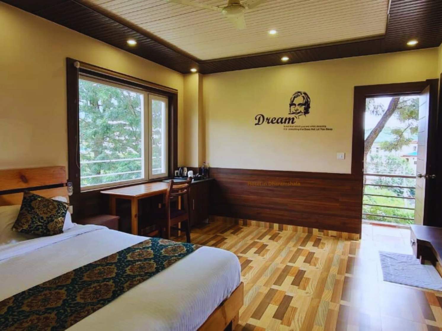 Superior room: a king-size bed, a desk, and a glass door open to a private balcony